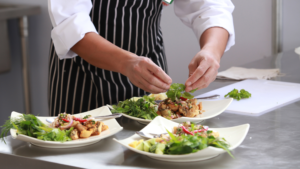 Chef preparing food at a restaurant signifying the F&B Industry Growth.