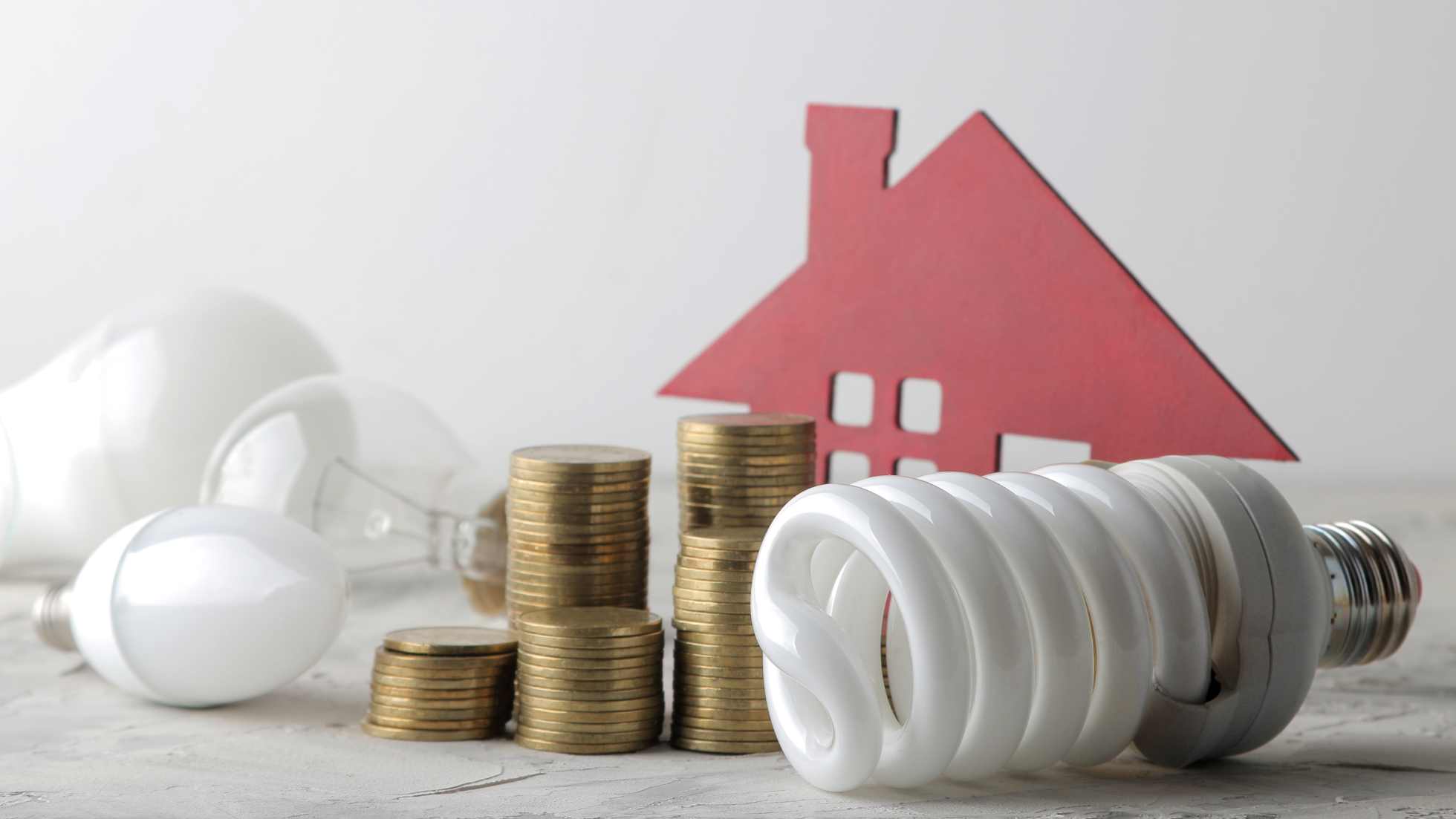 Indonesia GDP Q2 2025 growth illustrated by stacked coins, energy-efficient bulbs, and a house model representing economic and household spending.