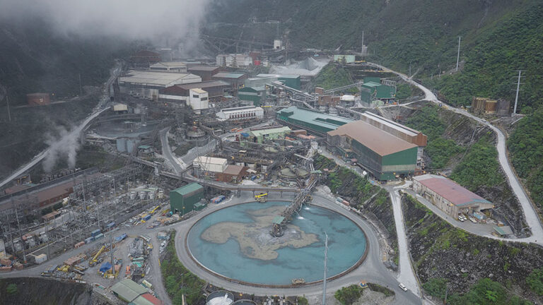 Aerial view of PT Freeport Indonesia’s ore mill surrounded by processing facilities, roads, and mountains, illustrating Indonesia’s mineral investments and downstream mining operations.