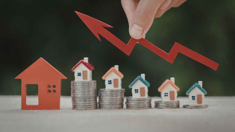 Bali Residential Property Prices concept showing miniature houses on stacked coins with a rising red arrow symbolizing market growth in Q4 2025.